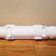 White, cylindrical plastic Sushi Bazooka device lying on wooden table